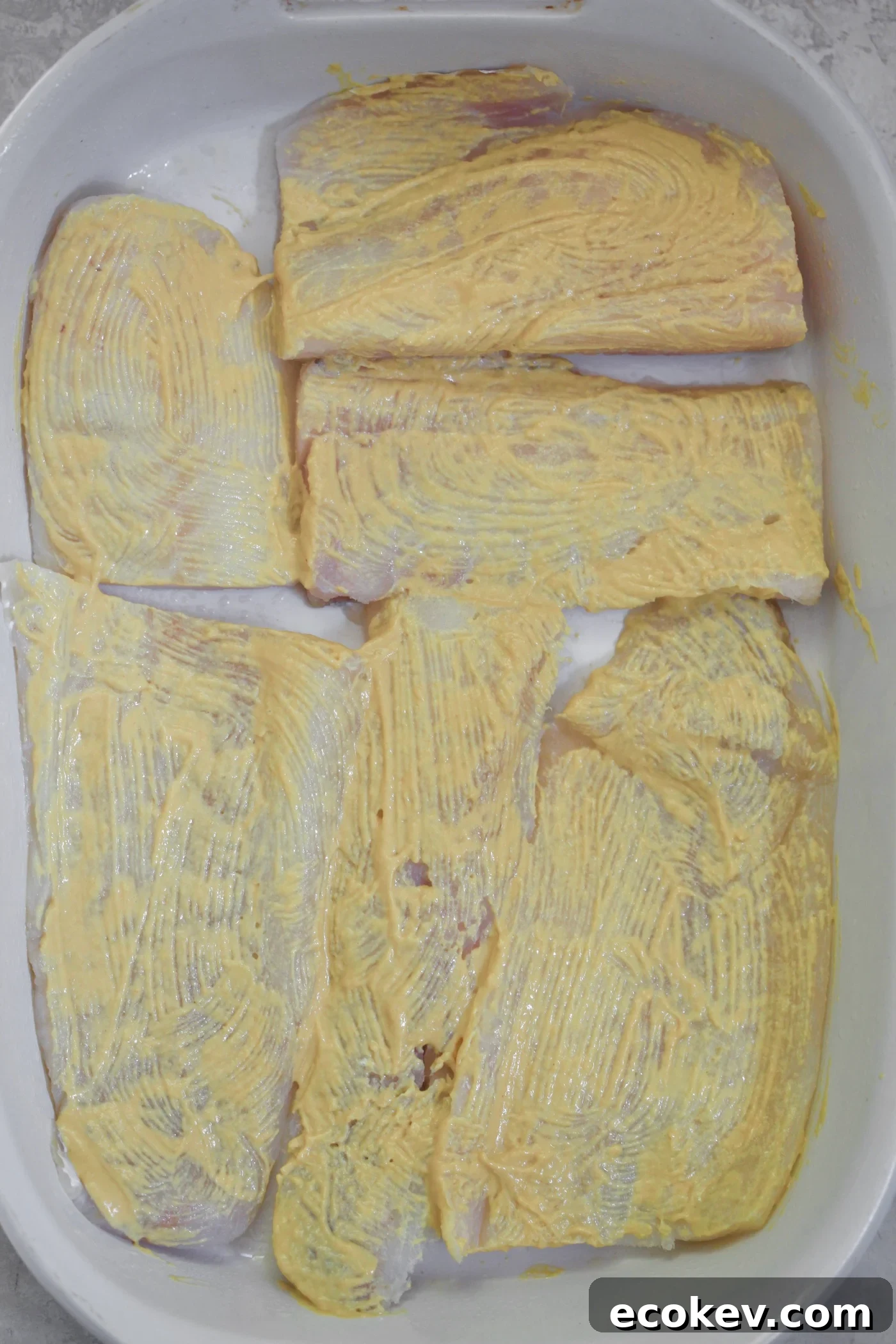 raw fish in baking dish with dijon