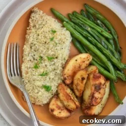 breaded fish on plate with potatoes and green beans