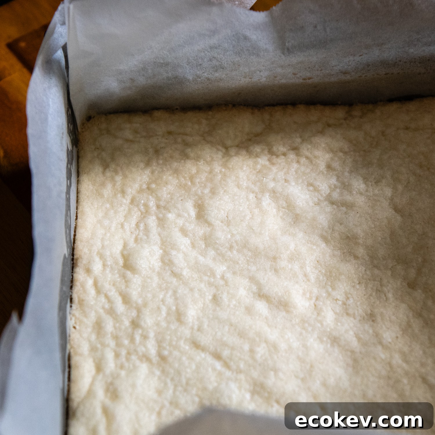 Baked dough in parchment paper in a pan.