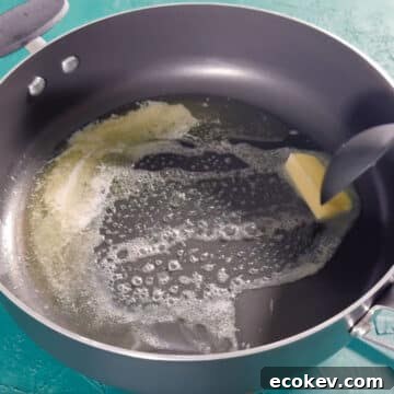 Butter  being heated in a large nonstick pot. 