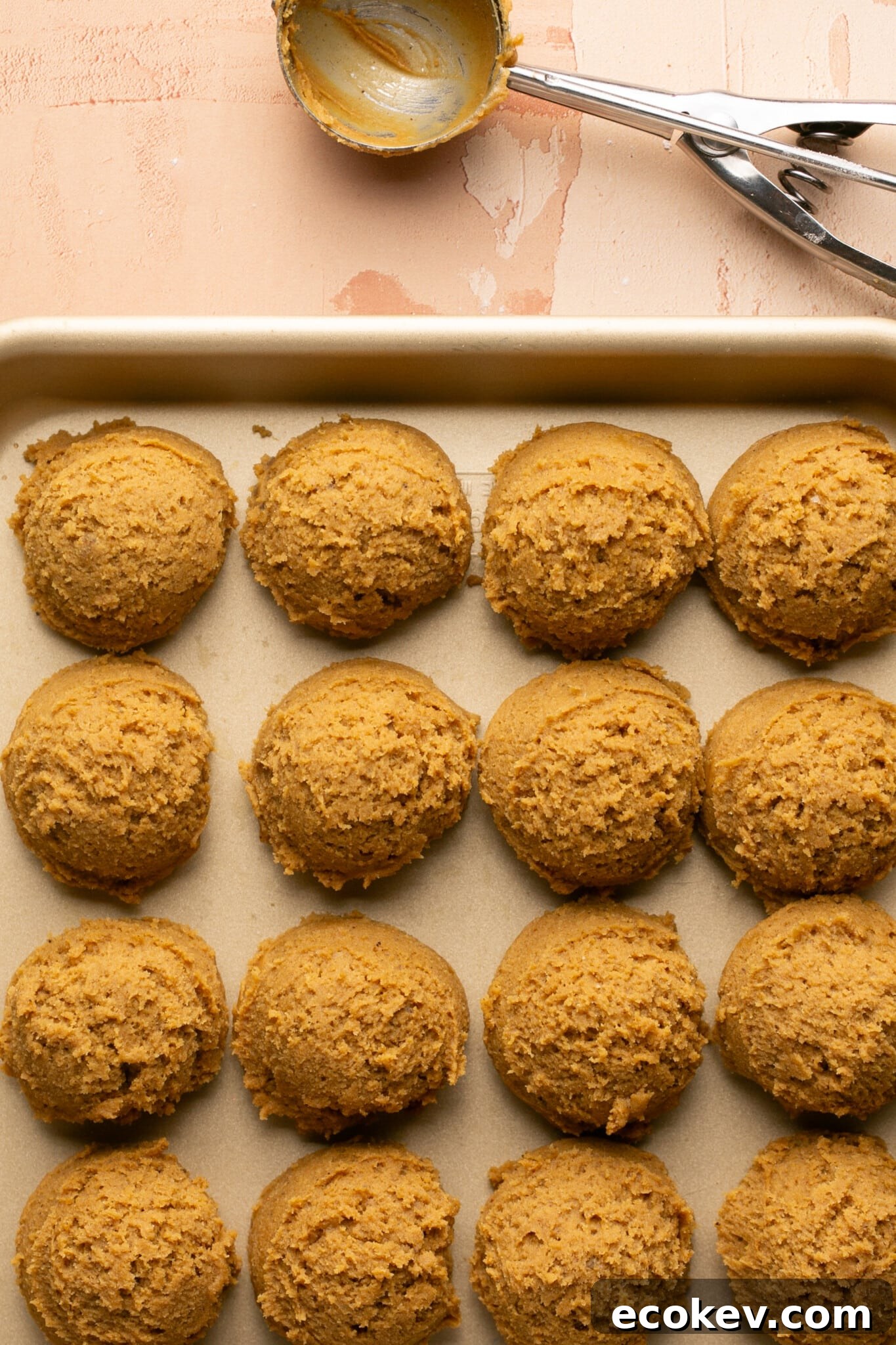 cookie dough scooped onto a baking sheet. 