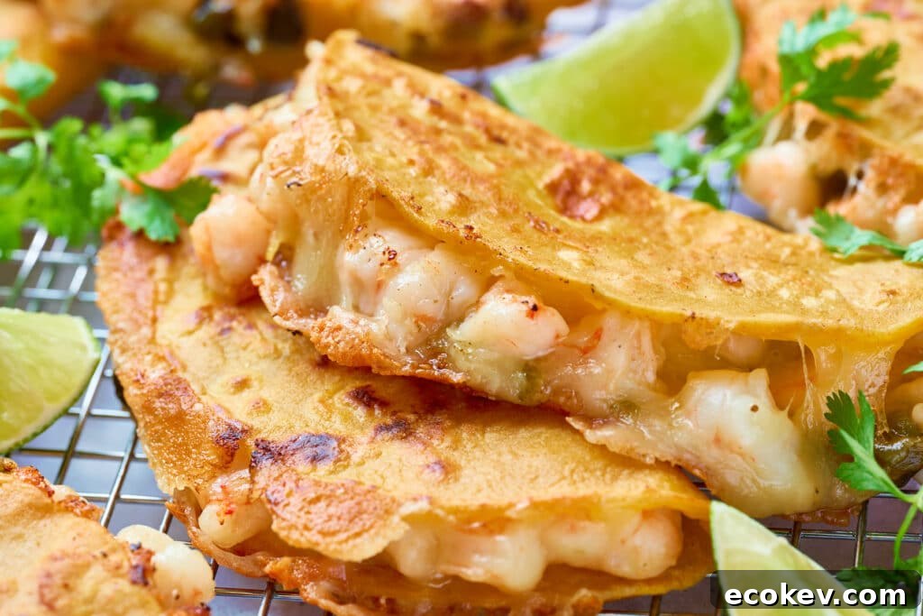 Golden brown, crispy and cheesy shrimp tacos on a rack.