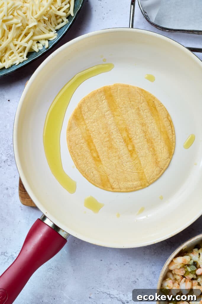 Crisping up a corn tortilla in a skillet