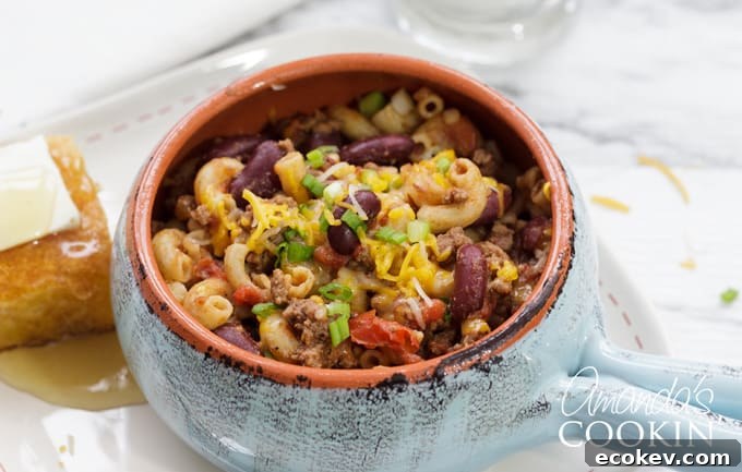 bowl of chili mac with cornbread and honey