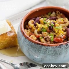 chili mac in a bowl with cornbread on the side