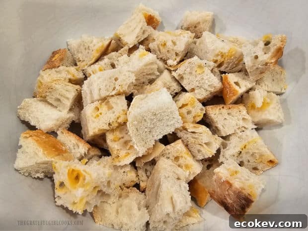 Sourdough or French bread is cut into cubes and placed in a bowl.
