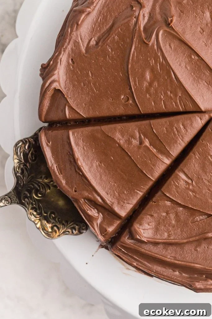 Air fryer cake frosted with a slice being pulled out.