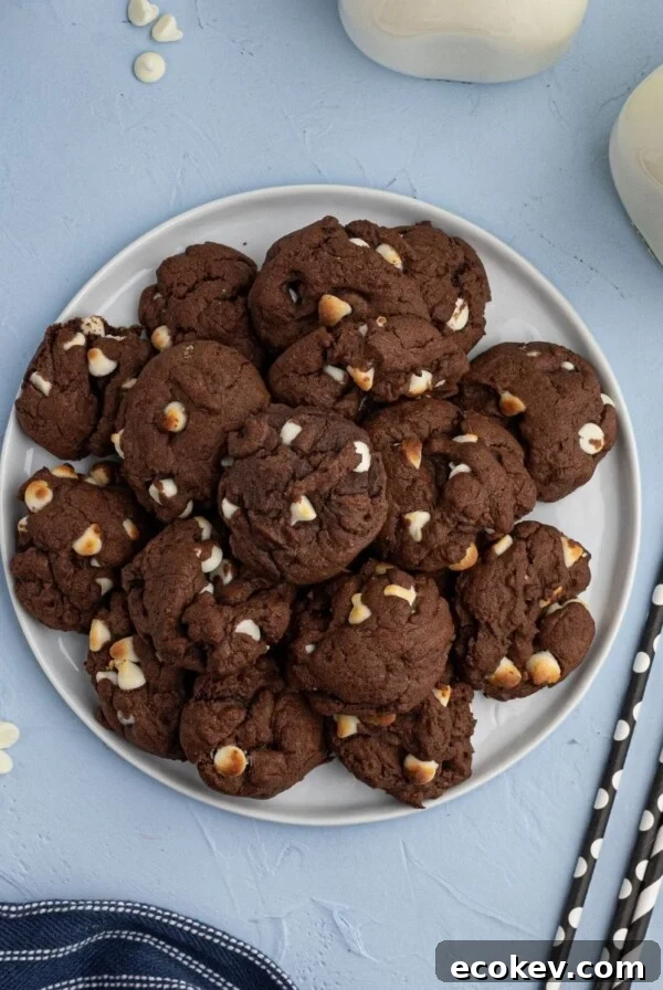 Chocolate Cookies with white baking chips, stacked on a plate. Chewy and moist air fryer cookies.