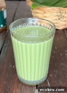Betel leaves drink served in a tall glass, showcasing vibrant green color and traditional Indian beverage.