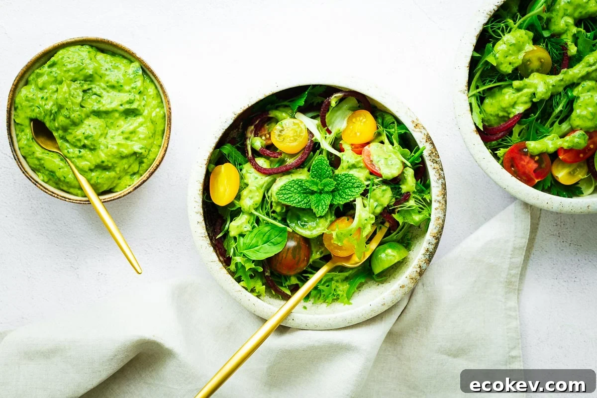 A top down view of salad bowls with an avocado green goddess salad dressing.