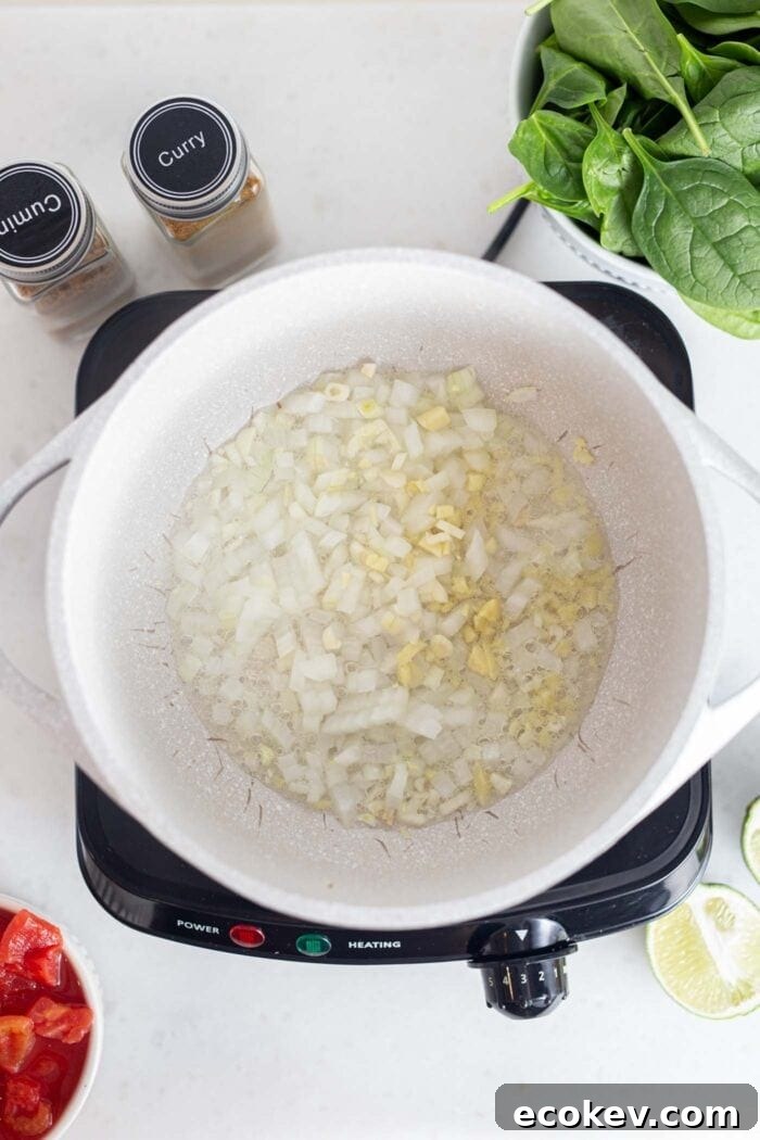 Onions, garlic and ginger cooking in a pot.