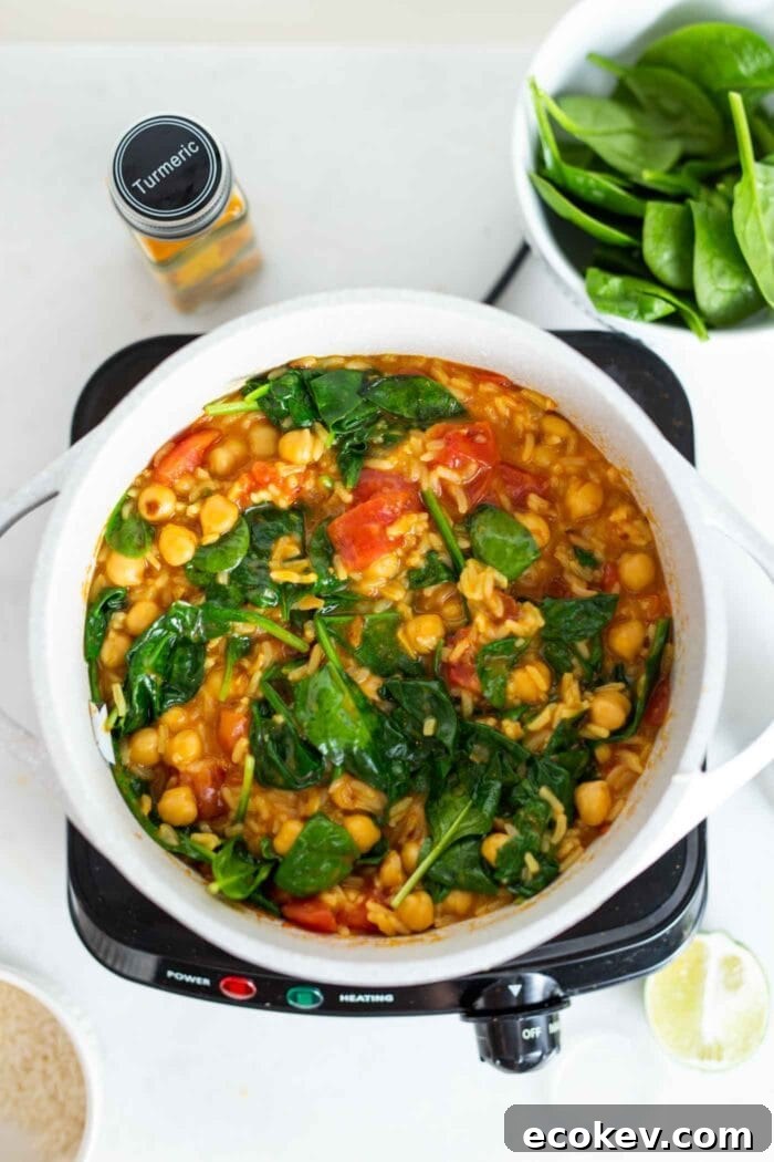 A pot of chickpea and rice stew with spinach.