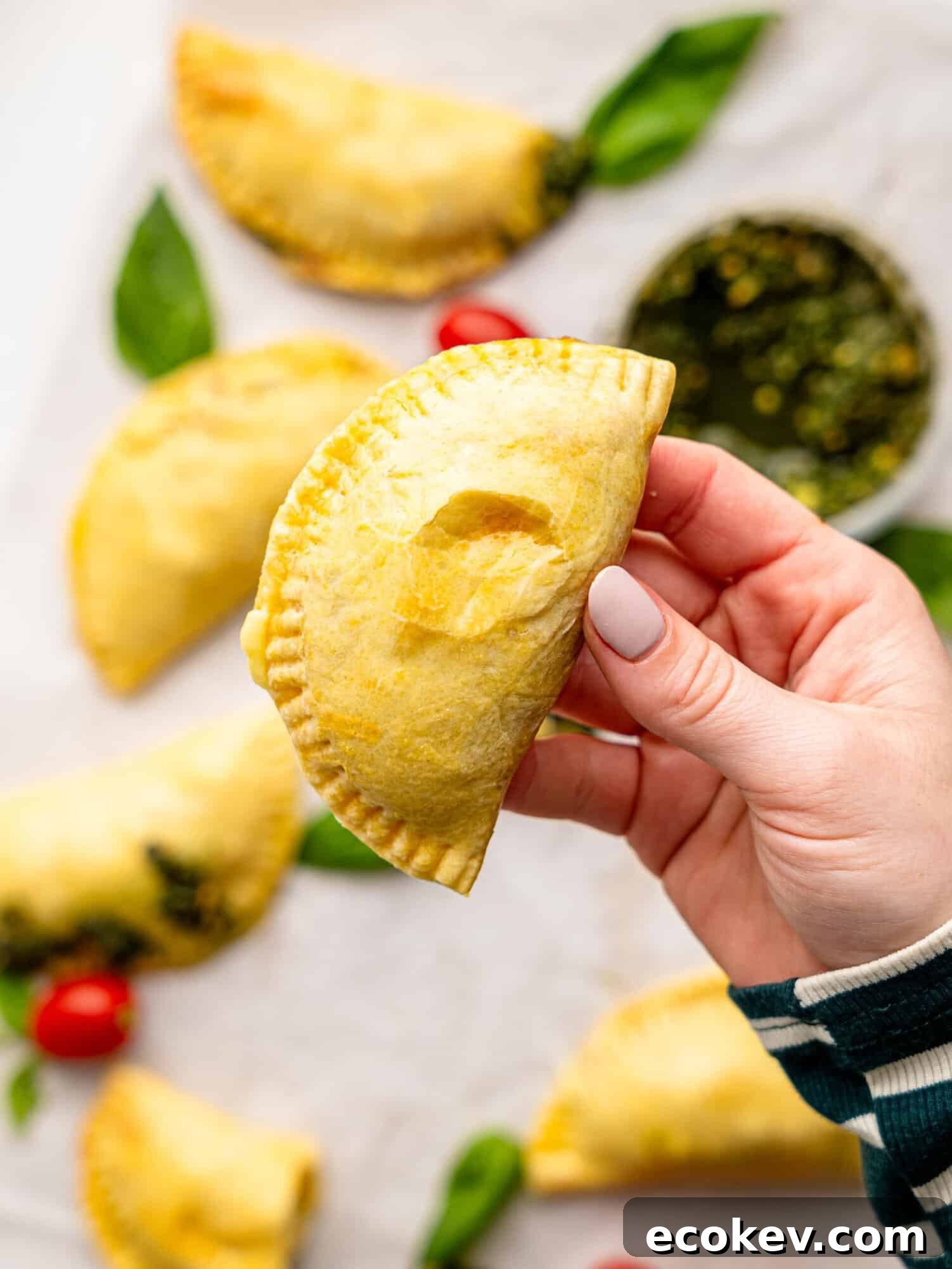 Someone holding an empanada.