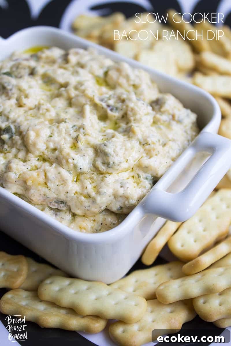 Slow Cooker Bacon Ranch Dip is my go to dip for game day. Super cheesy and studded with bacon, this easy to make dip is always a crowd pleaser!