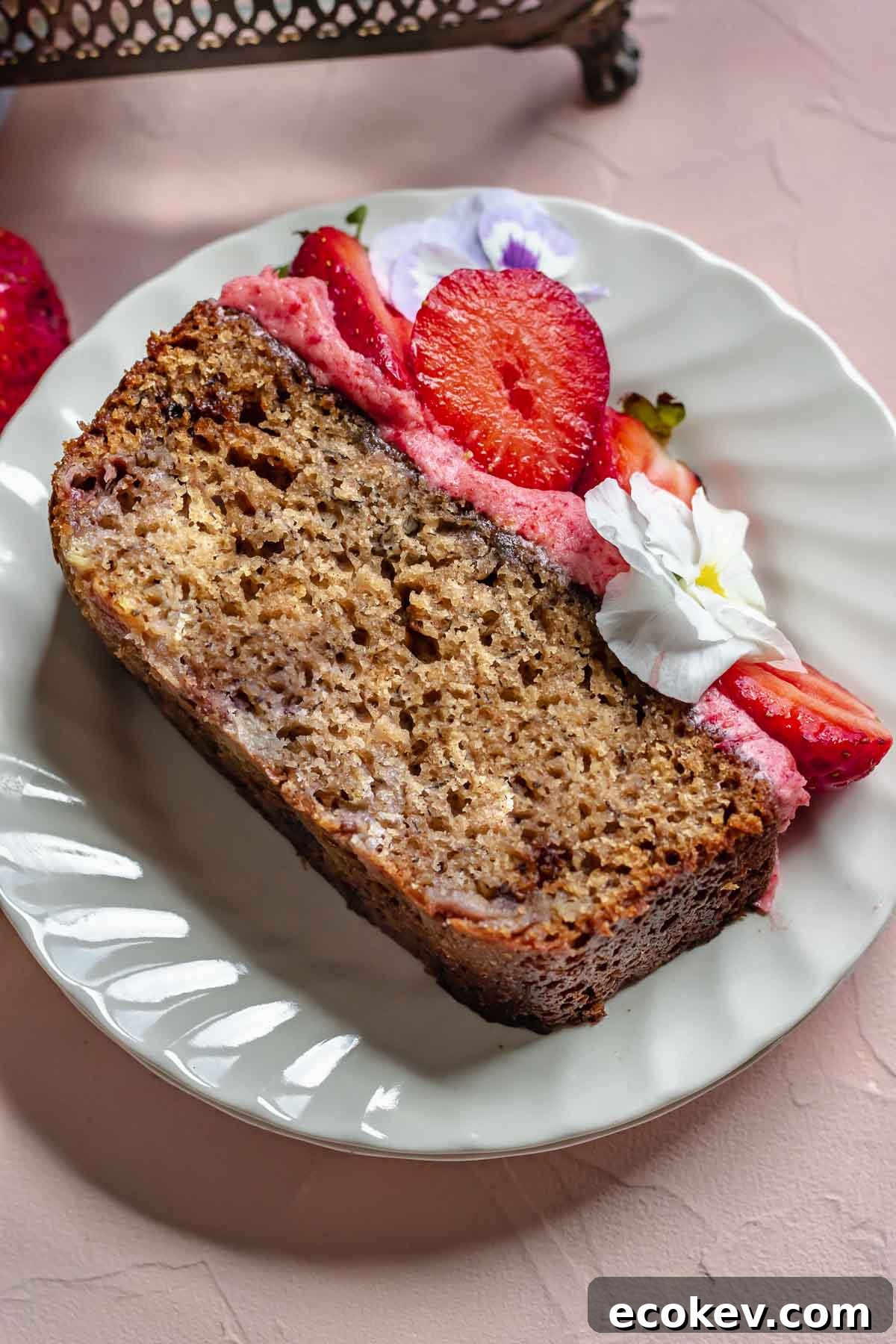 Slice of strawberry banana cake on a plate.