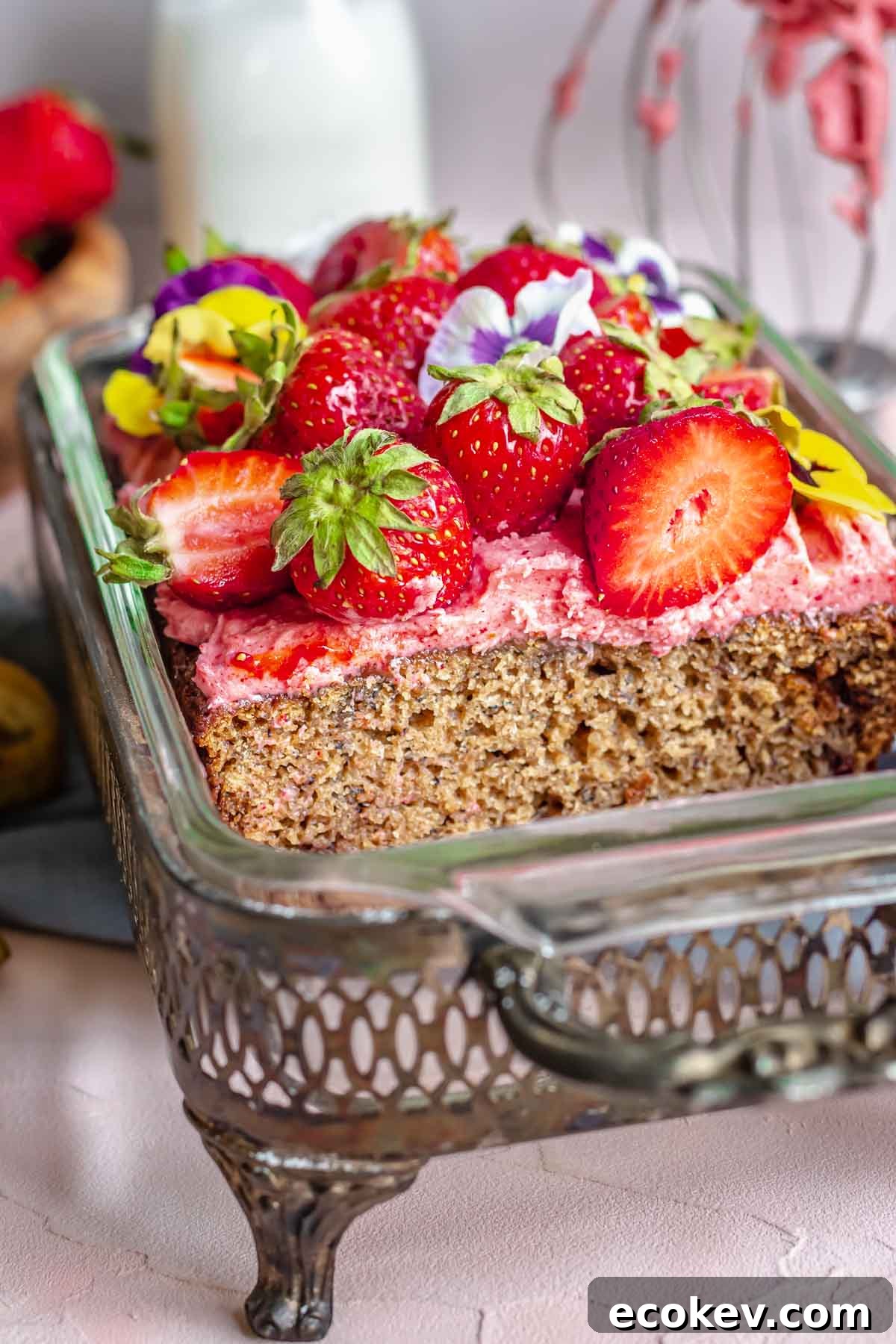 Strawberry banana cake decorated in a loaf pan.