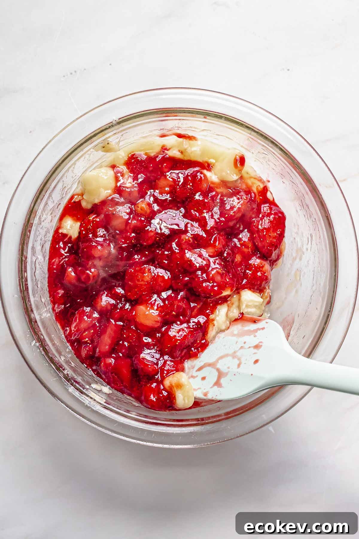 Mashed strawberries and bananas in a bowl.