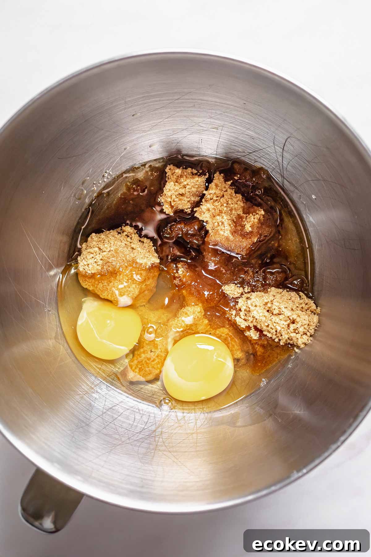 Wet ingredients in the bowl of a stand mixer.