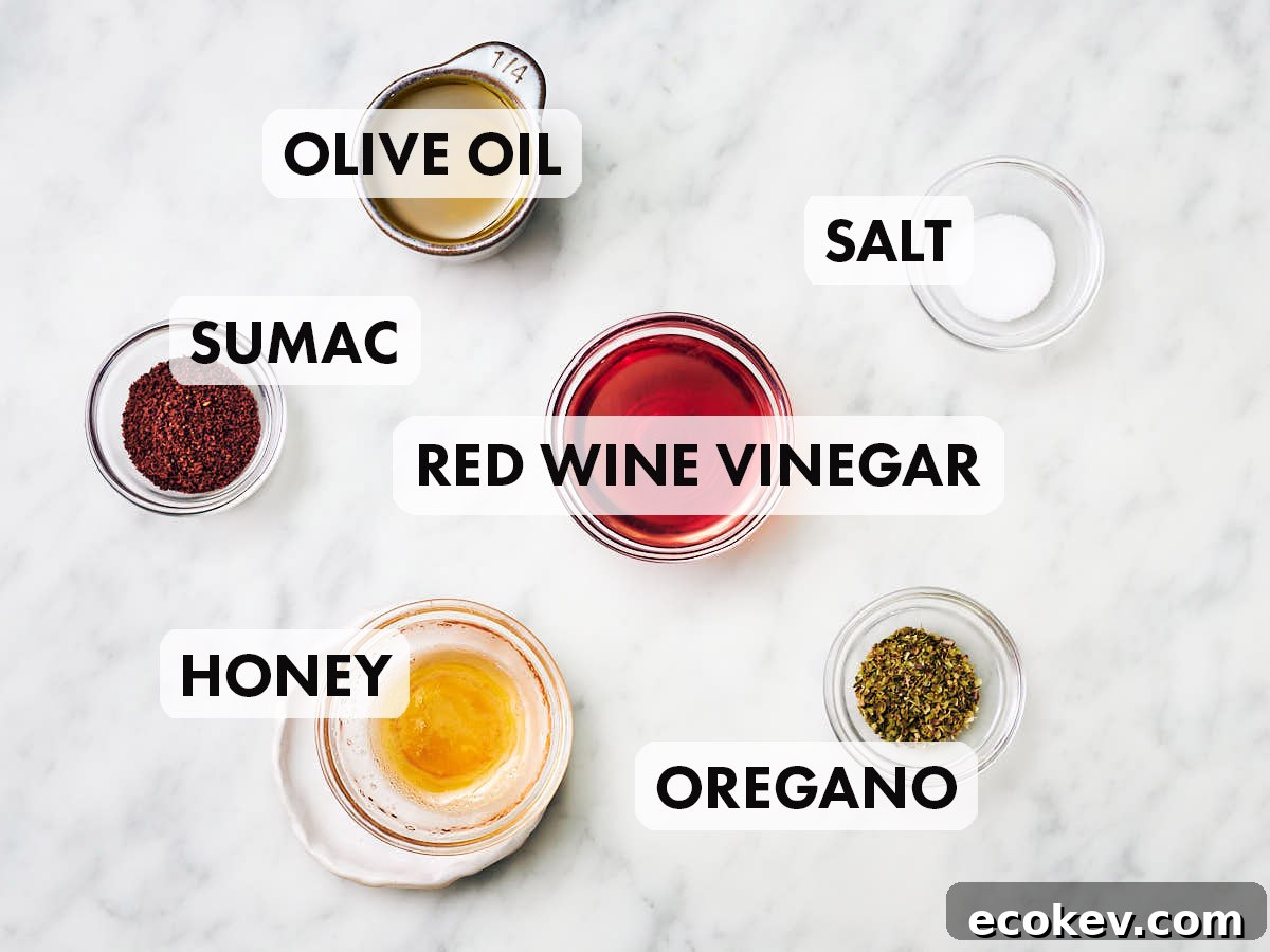 Ingredients to make Sumac dressing (olive oil, red wine vinegar, sumac, oregano, salt, honey).