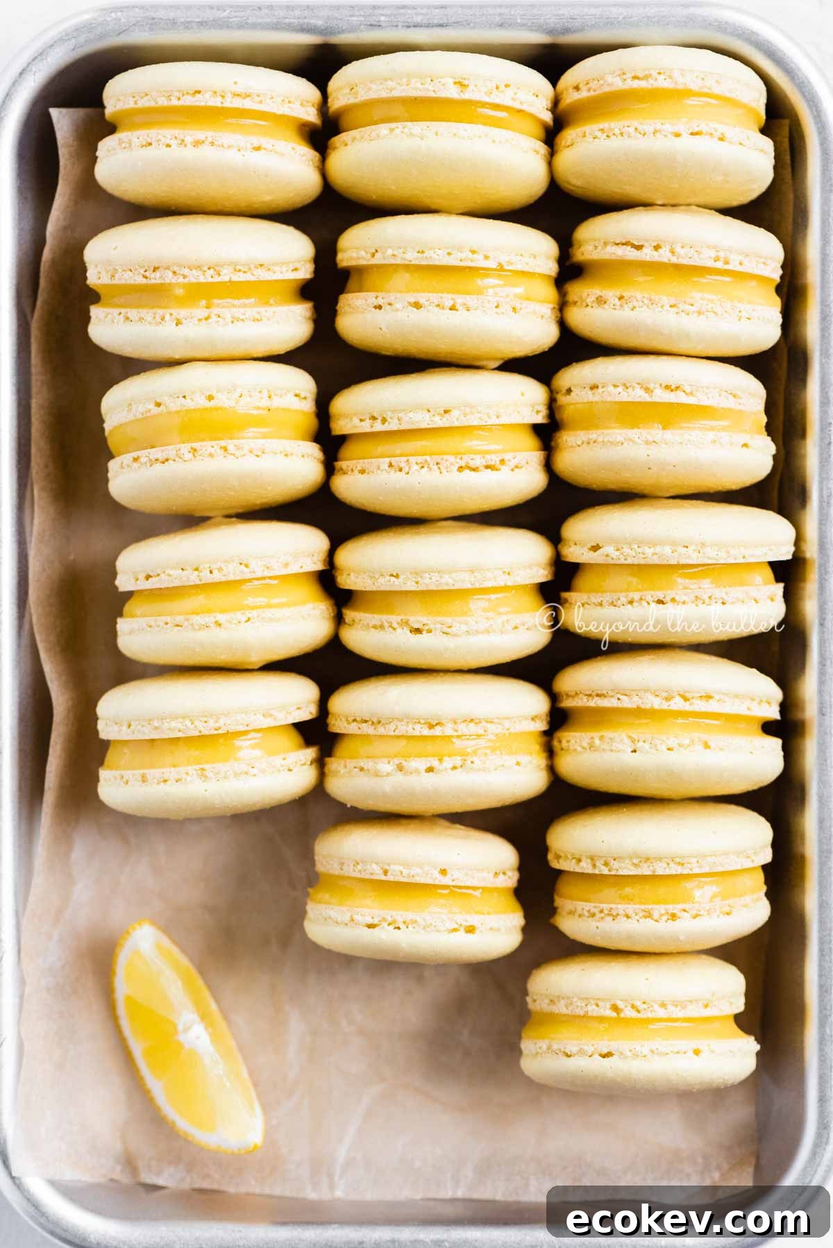 Close up of lemon bar macarons on side on a baking tray | All Images © Beyond the Butter™