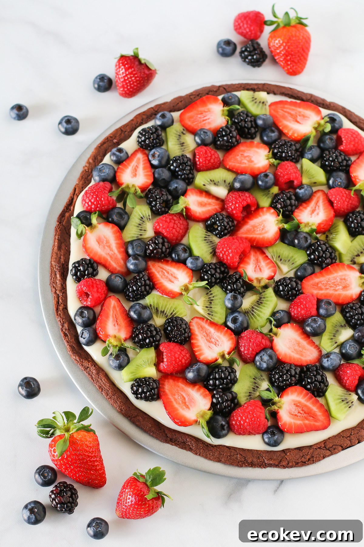 Gluten Free Vegan Brownie Fruit Pizza. Chocolate brownie crust with a cream cheese frosting, loaded with fresh fruit. A beautiful dessert pizza!