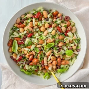 A white bowl filled with a vibrant Mixed Bean Salad.