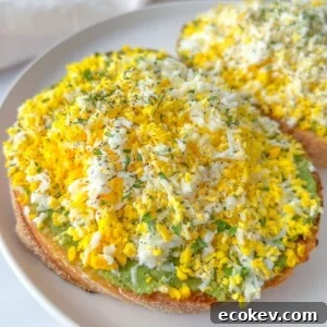 Toast topped with avocado and finely grated hard-boiled egg.