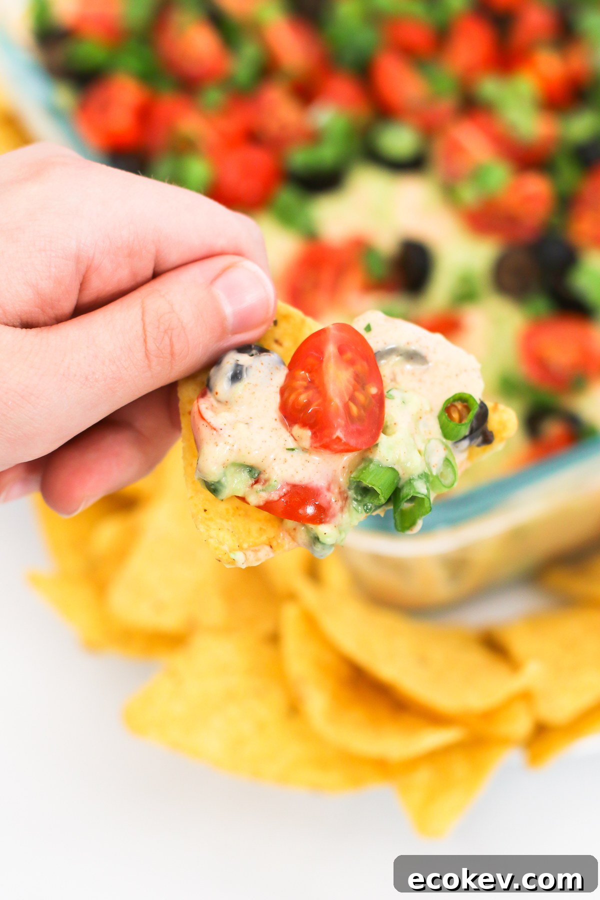 Vegan 7 Layer Bean Dip. Layers of beans, guacamole, creamy taco sauce, salsa and all of the vibrant Mexican flavors. No one will even miss the dairy! 