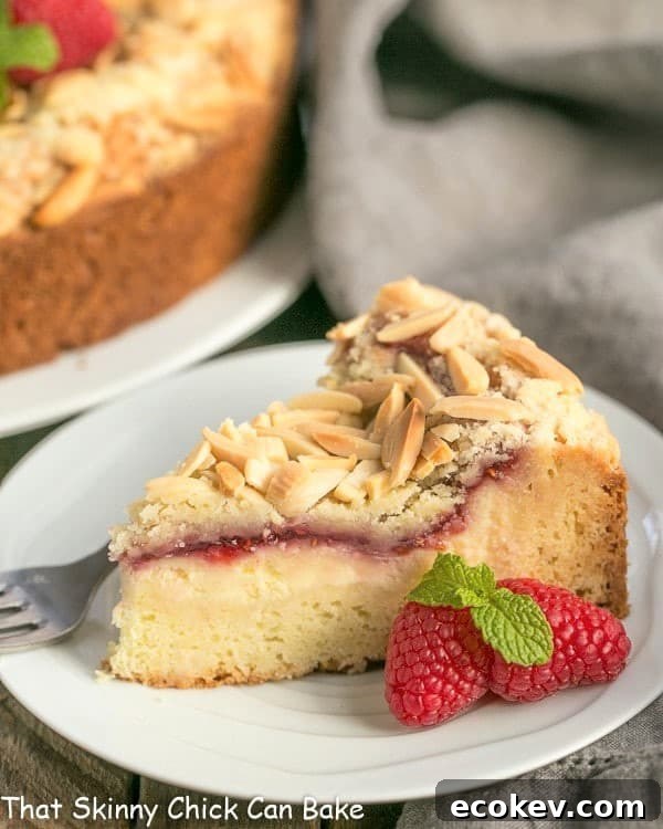 Raspberry Cream Cheese Coffee cake slice on a small white plate.