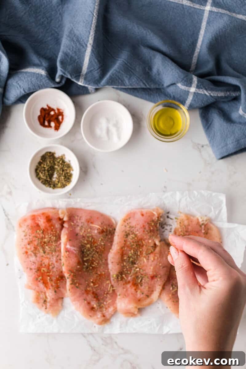 seasoning the chicken breasts.