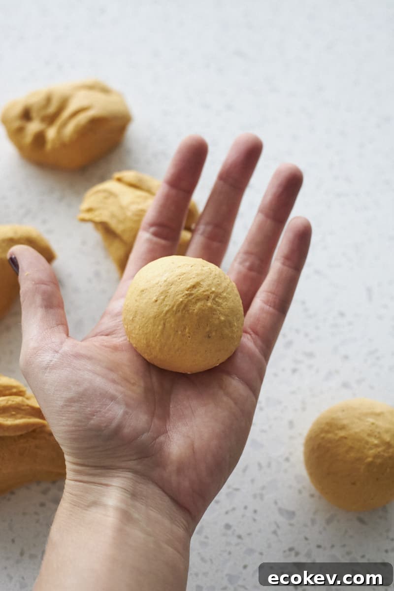 Dinner rolls shaped in the palm of a hand.