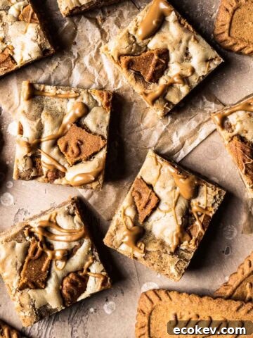 Cookie butter squares on brown parchment paper.