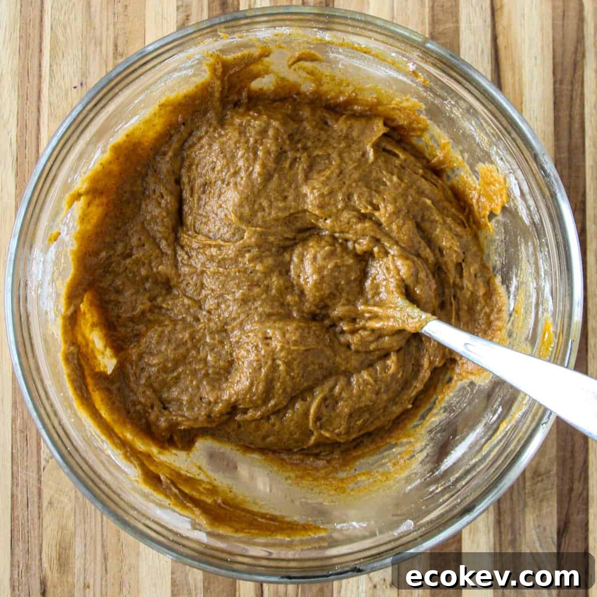 The finished batter for the pumpkin loaf in a glass bowl.