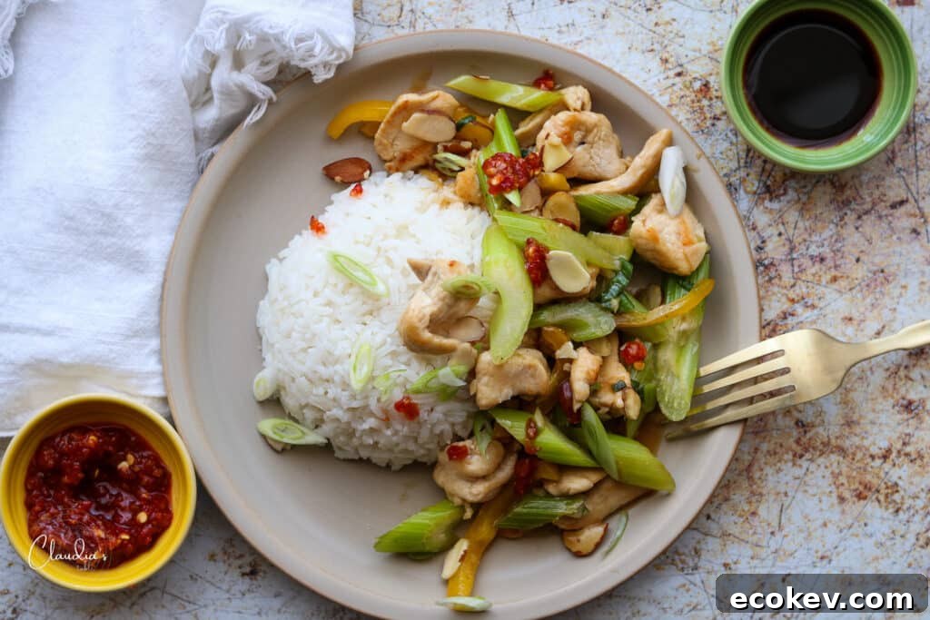 easy almond stirfry with steamed rice soy and chili sauce on the sides.