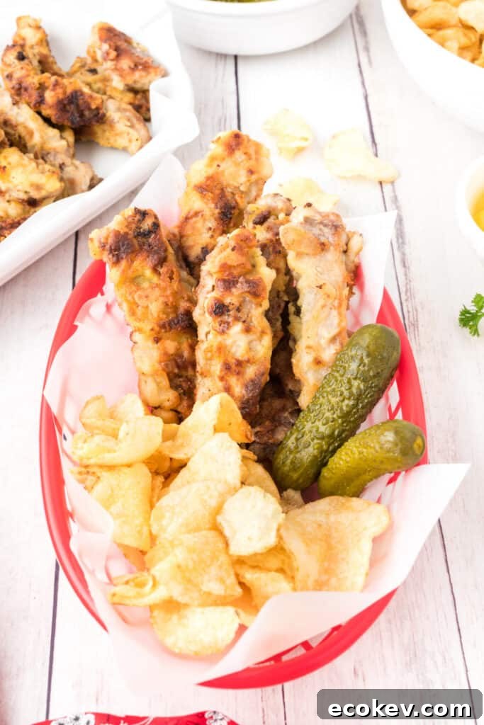 red food basket with steak fingers, potato chips, and pickles