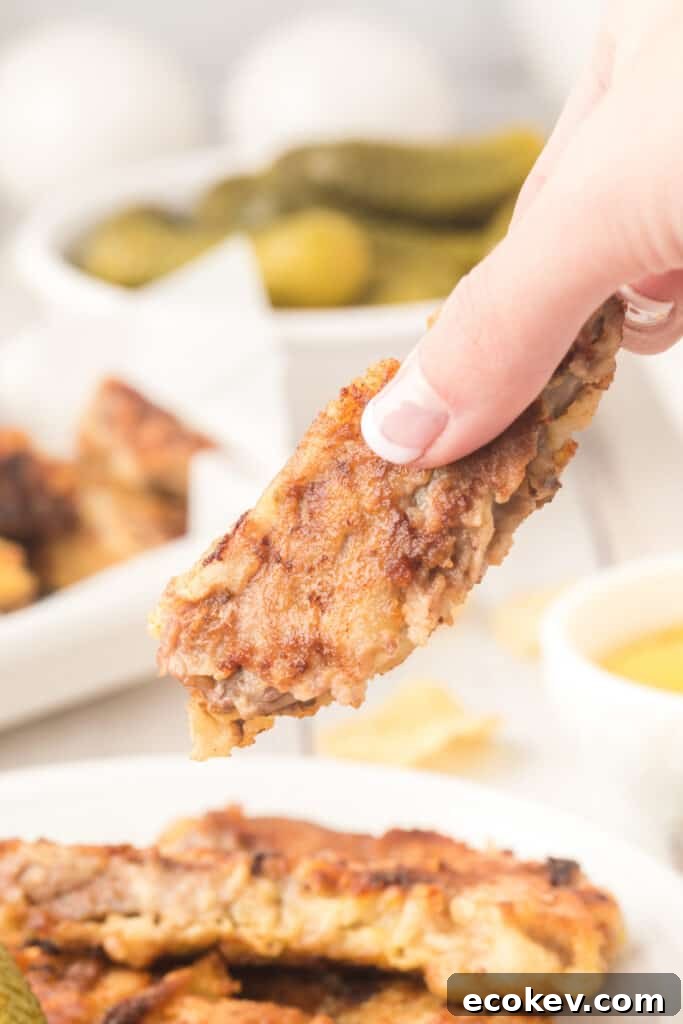 hand holding a steak finger