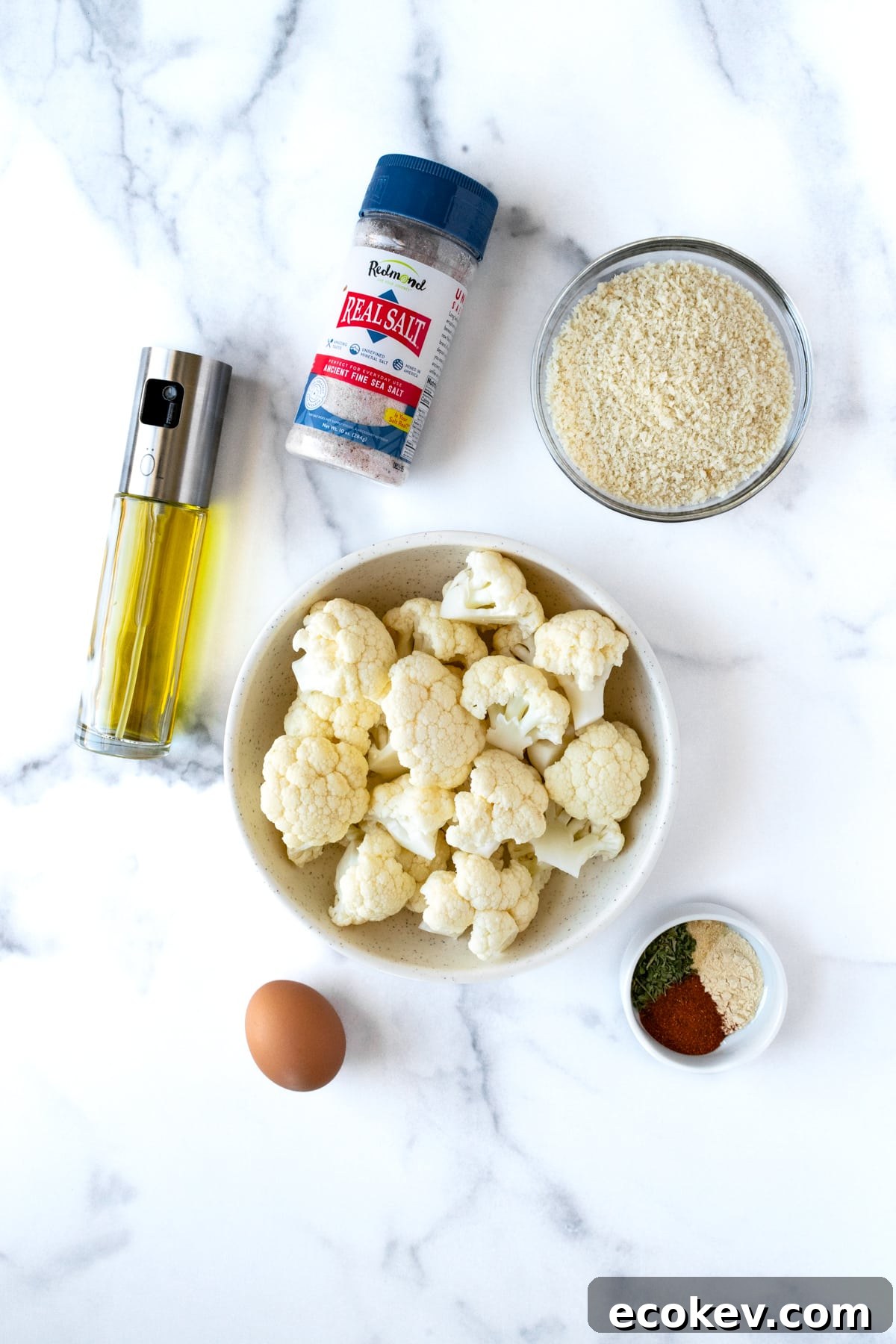 Crispy Cauliflower Bites Ingredients on a marble countertop.
