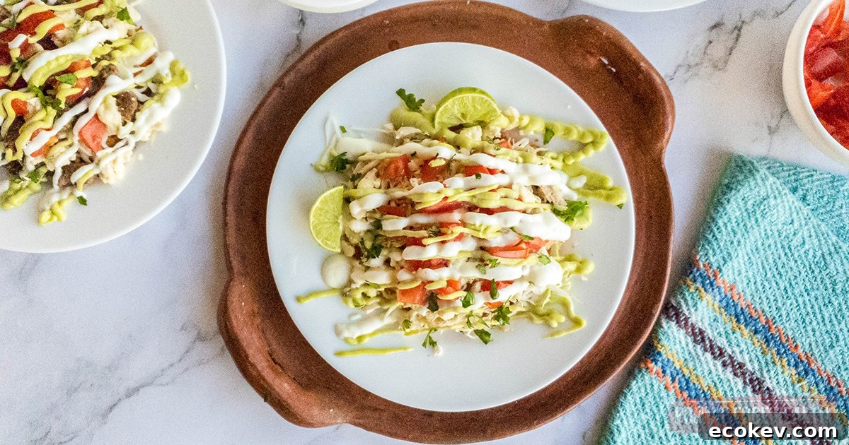 Keto tostada with all the toppings on a white plate on marble surface.