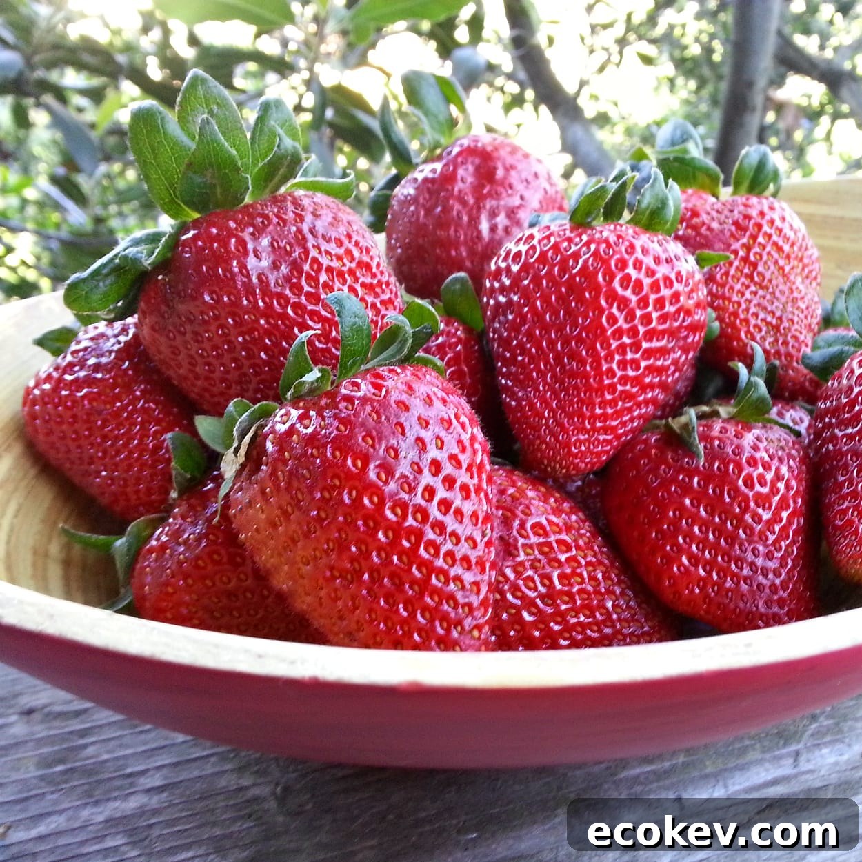 wood bowl filled with strawberries