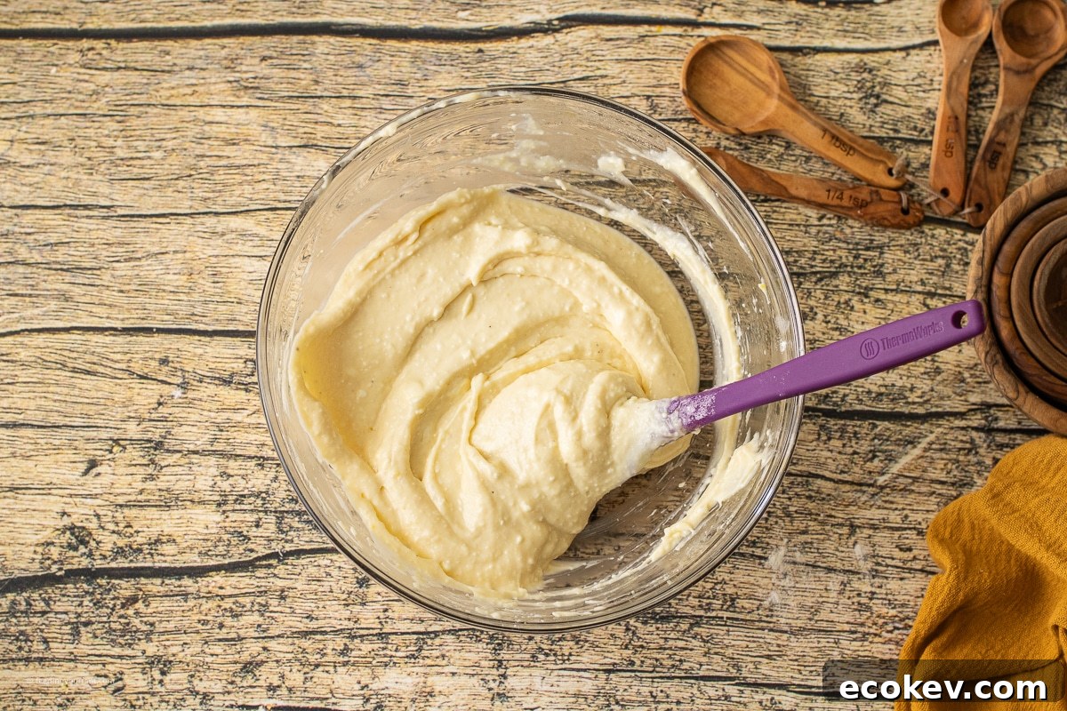 cream cheese, flour, egg, and sugar combined to make a baked cream cheese layer in a pumpkin skillet cookie