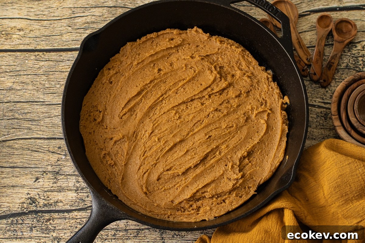 preparing a pumpkin cookie baked in a cast iron skillet 