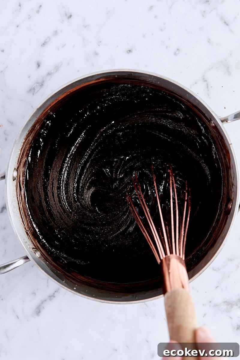 Egg, egg yolk, and vanilla extract whisked into brownie batter