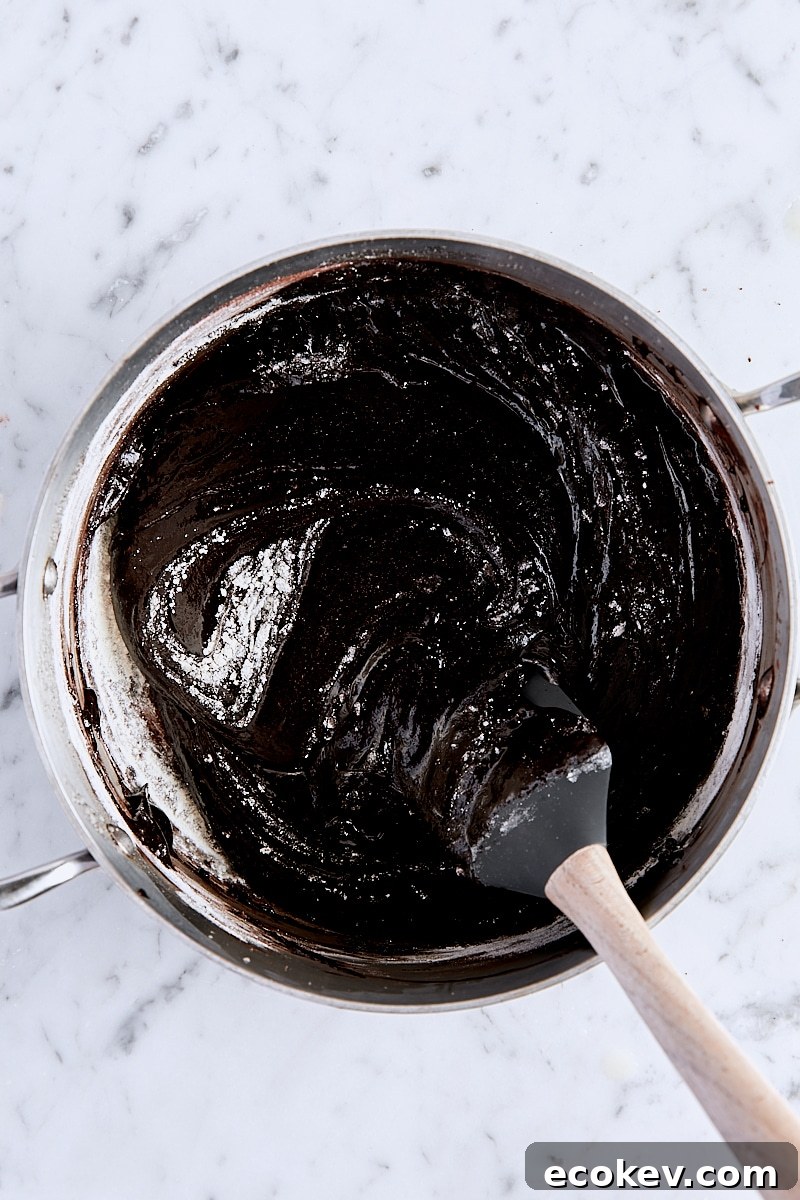 Flour folded into brownie batter with a spatula