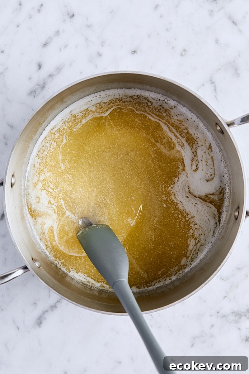 Melted butter in saucepan with small spatula