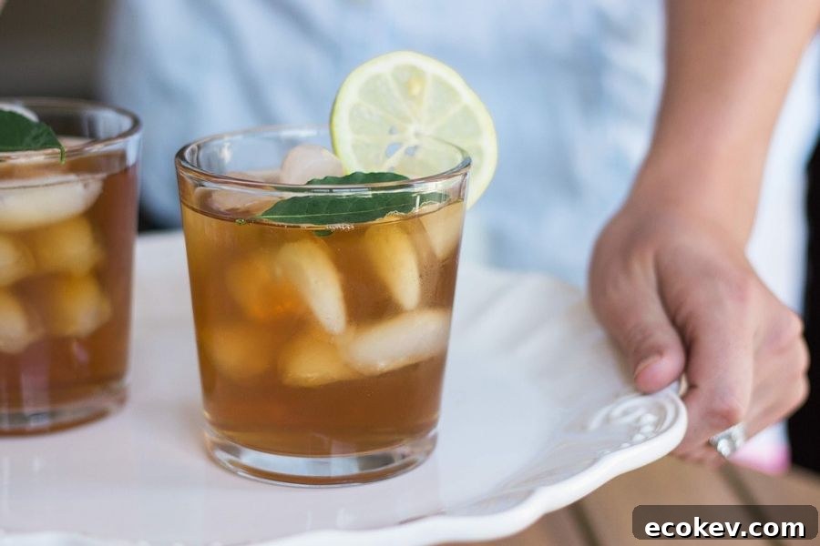 A woman holding a tray topped with iced tea - Greek Mountain Tea is the perfect Greek souvenir to bring home!