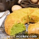 A pandan chiffon cake with a piece missing.