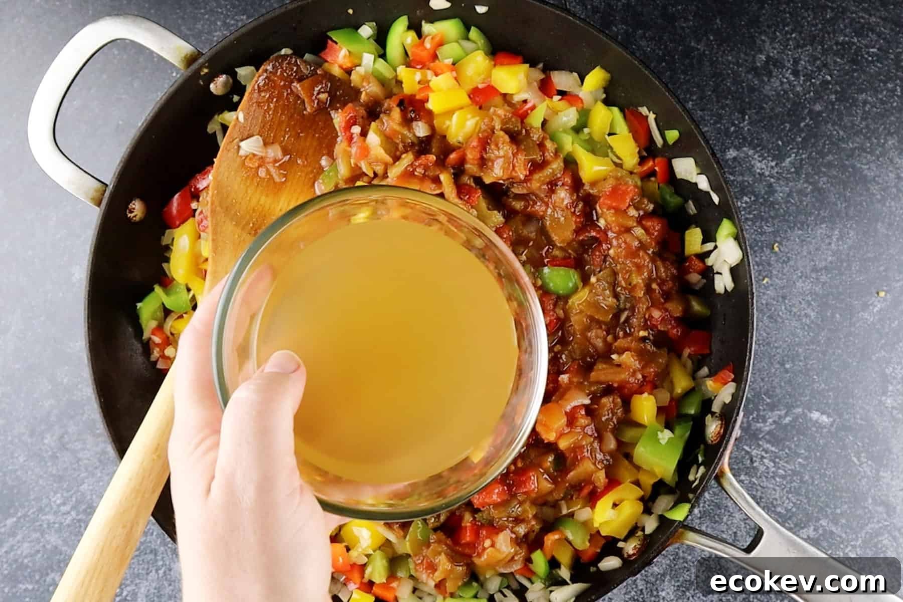 adding broth to skillet