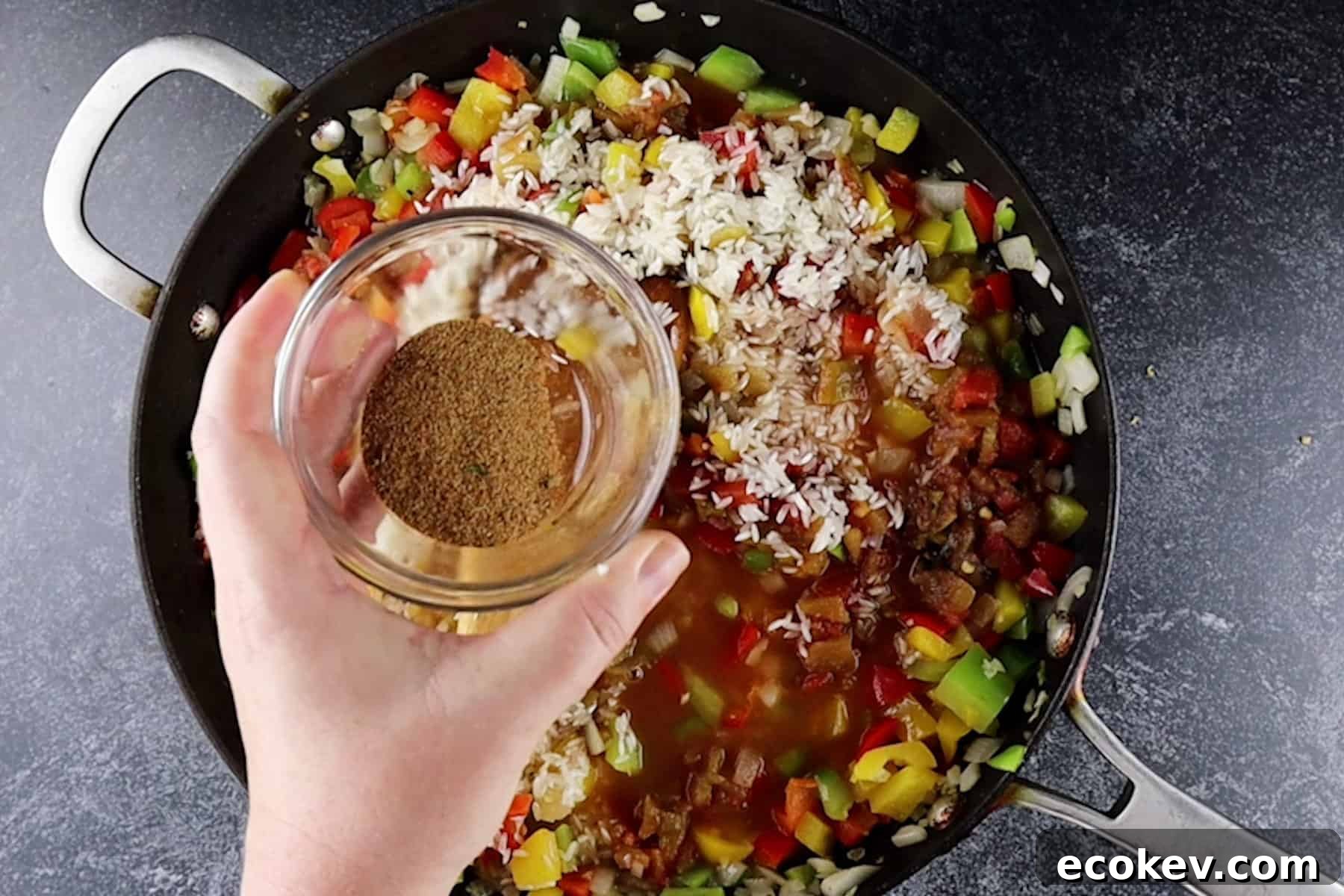 adding spiced to rice