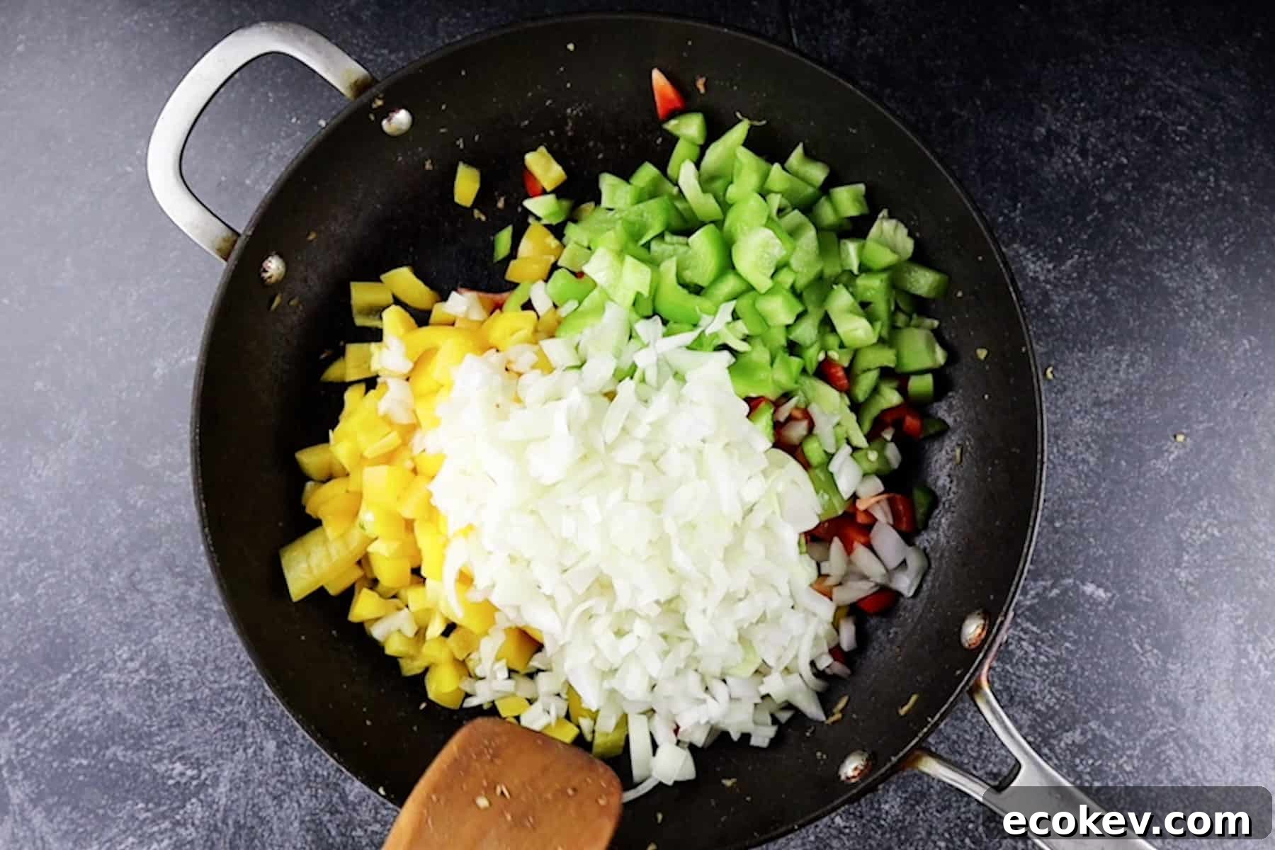 adding bell pepper and onion to pan