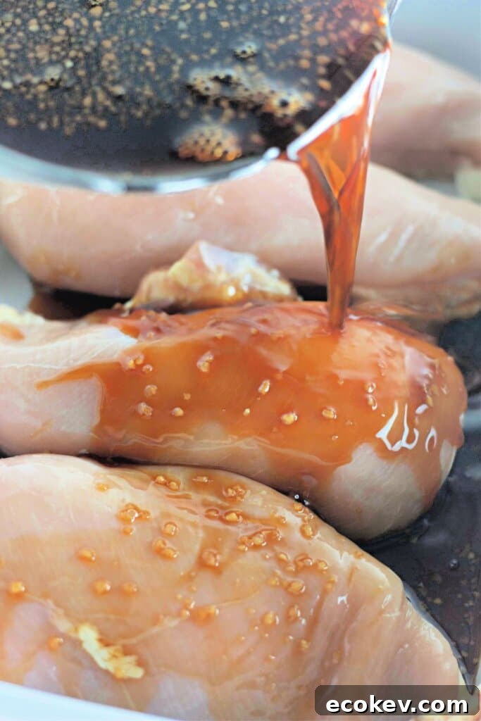 Soy sauce being poured over meat in a slow cooker.
